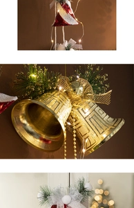 Detail of golden Christmas bell ornaments with LED lights, gold mesh bows and pine needles