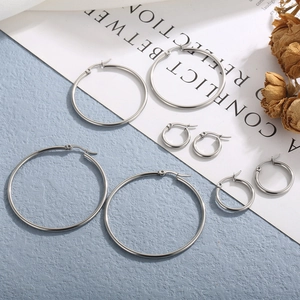 Set of four polished silver stainless steel hoop earrings in various sizes for women