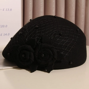 Detailed shot of black wool beret featuring 3D roses, fine mesh veil and pearl accents