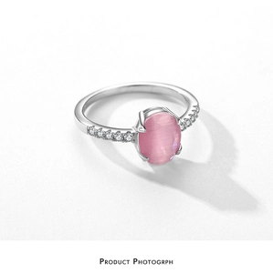 Close-up of S925 silver ring with oval pink cat eye stone and pavé set side stones
