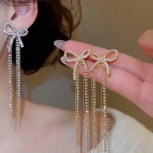 Elegant bow zircon tassel earrings for women in gold and silver finish with crystal fringe