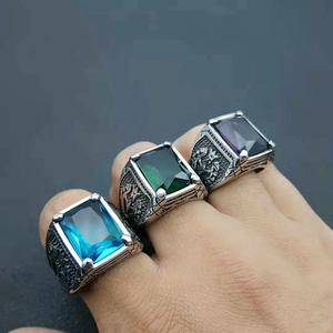 Macro view of retro punk steel rings with multicolored gemstones and tulip carvings