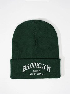 Detailed view of the dark green ribbed knit beanie with Brooklyn 1898 white embroidery