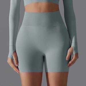 Detail view of seamless dusty blue high-waisted gym shorts and sleeve thumbhole design