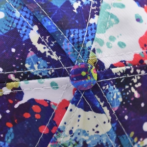 Macro detail of abstract colorful graffiti print on the crown of the baseball cap