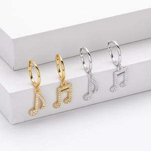 Close-up of S925 sterling silver music note earrings with sparkling rhinestones detail