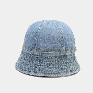 Detailed close-up of light blue denim bucket hat with decorative yellow stitching lines