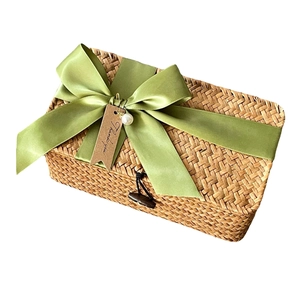 Handwoven seagrass gift box with a green satin bow and a Thank You tag