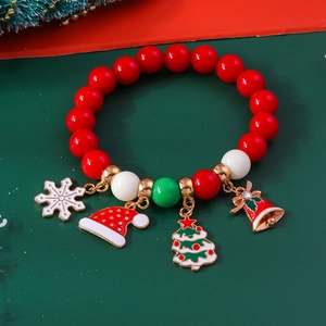 Close-up of Christmas beaded bracelet with snowflake, tree, and bell alloy pendants