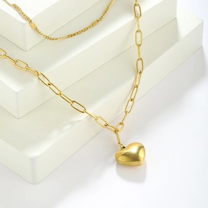 Close-up of gold 3D heart pendant necklace with modern paperclip chain detail