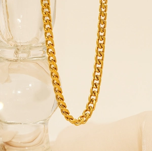 Detailed macro view of an 18K gold-plated stainless steel Cuban link chain necklace