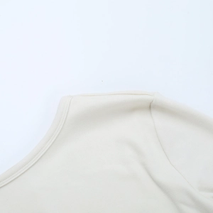 Detail of delicate lace collar and shoulder stitching on a white knitted bodycon dress