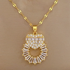 Macro shot of gold heart pendant with glittering white zircon and rectangle crystals
