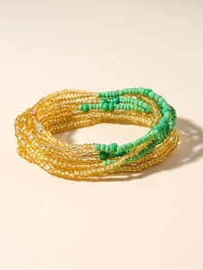 Detailed macro shot of multi-layer handmade golden and green beaded bohemian body chain