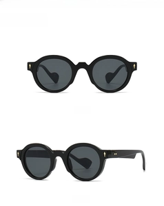 Front and side view of black thick-frame sunglasses with iconic gold arrow rivets