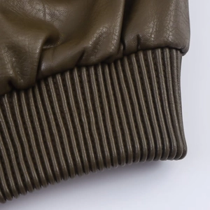 Détail d'une veste en cuir vert olive foncé montrant les poignets en maille côtelée