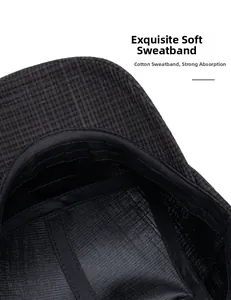 Detail of soft cotton inner sweatband on a dark grey plaid baseball cap