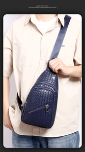 Close-up of a blue woven PU leather chest bag worn by a model in a casual business style