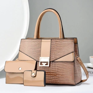 Beige crocodile pattern three-piece handbag set with tote, pouch, and golden hardware