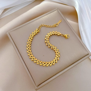 Detailed close-up of 18K gold-plated V-shaped chain link bracelet with lobster clasp