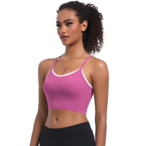 Detail of pink cross-strap sports bra featuring a two-tone design and soft brushed fabric
