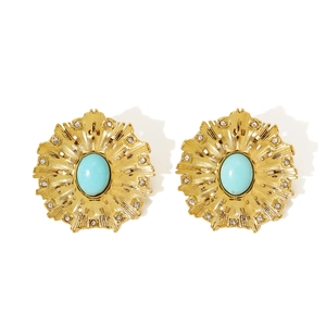 Close-up of vintage gold floral earrings with turquoise stones and clear rhinestones
