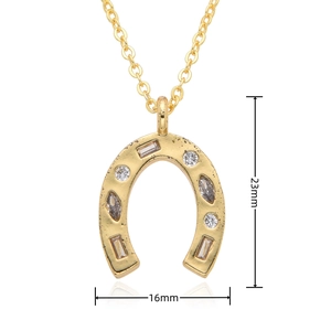 Detailed view of 18k gold horseshoe pendant with zircon stones and 23mm x 16mm dimensions