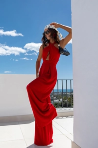 Close-up of bright red halter jumpsuit with textured fabric and cutout waist design
