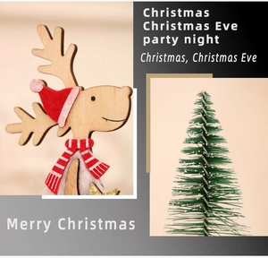 Detail of wooden reindeer with a red hat and mini snowy Christmas tree decoration