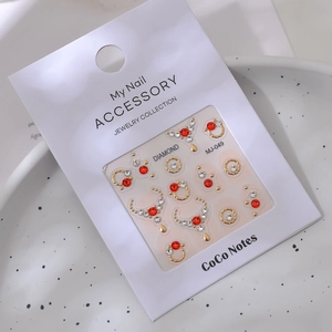 Detail of MJ-049 nail art jewelry set featuring red rhinestones and gold metal charms