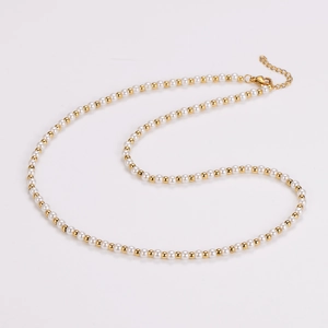 Detail of vintage pearl necklace with gold beads, lobster clasp and extension chain