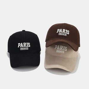 Detailed view of Paris French embroidery on black, brown, and khaki cotton baseball caps
