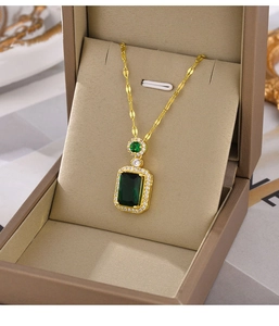 Detailed macro view of a vintage emerald-cut green gemstone pendant in gold box