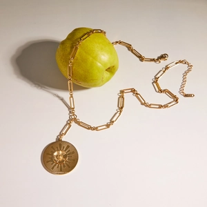 Detail of 18K gold camellia coin pendant on paperclip chain with K18 stamp