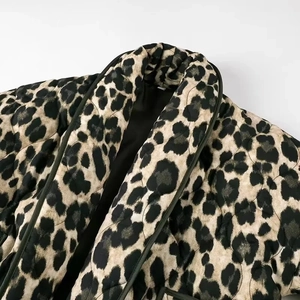Close-up of leopard print quilted winter jacket featuring stand collar and stitched texture