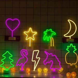 Collection of decorative LED neon signs in flamingo and pineapple shapes with white bases
