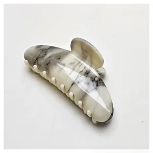 Close-up of marble texture on water transfer claw clip with elegant ink pattern detail