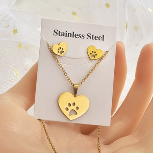 Detail of gold stainless steel heart necklace and earrings with hollow cat paw design
