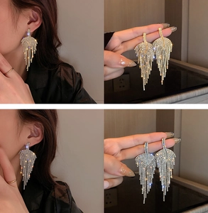Detailed view of U-shaped pearl tassel drop earrings with sparkling rhinestones for women