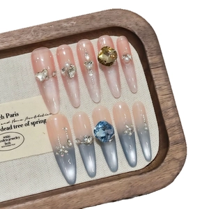 Pink and blue cat-eye handmade press-on nails with luxury rhinestones and long stiletto shape