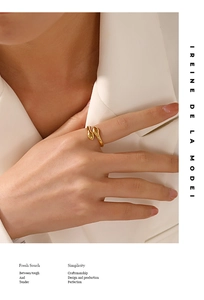 Detail of minimalist 18K gold plated double-headed snake ring worn on model hand