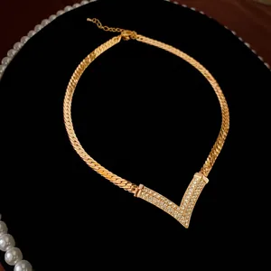 Gold plated vintage V-shaped necklace with shimmering crystals and flat snake chain