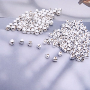 Macro detail of high-shine S925 sterling silver loose beads for DIY jewelry making