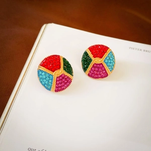 Macro shot of vintage round studs with colorful rhinestones on an open magazine
