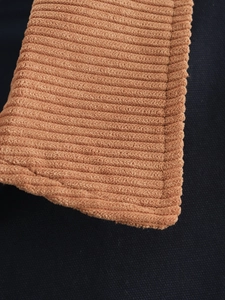 Detailed close-up of premium corduroy fabric texture and stitching on cotton jacket