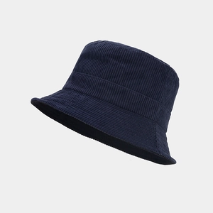 Close-up of dark blue corduroy bucket hat showing vertical texture and reinforced stitching