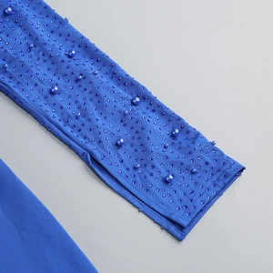 Detail of royal blue sleeve with luxury rhinestones and scattered blue pearls embellishment