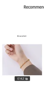 Detail shot of a polished 18K gold-plated oval link chain bracelet on a wrist