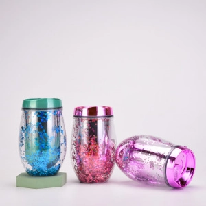 Detailed close-up of double-walled glitter tumblers in blue, pink, and purple colors