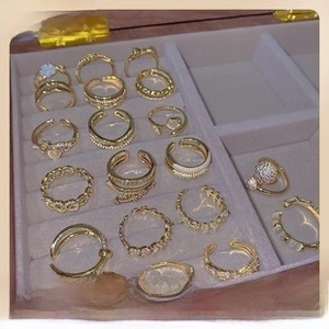 Detailed top view of gold-plated adjustable ring set with pearls and zircons in jewelry box